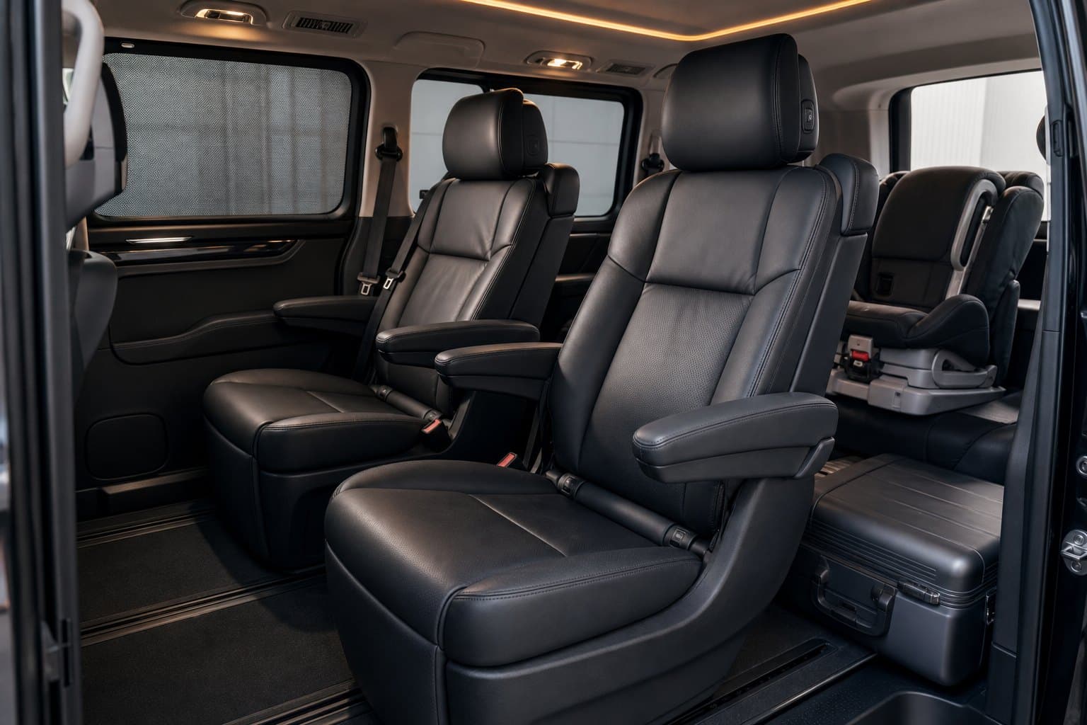 Private transfer vehicle interior with child seat and luggage space